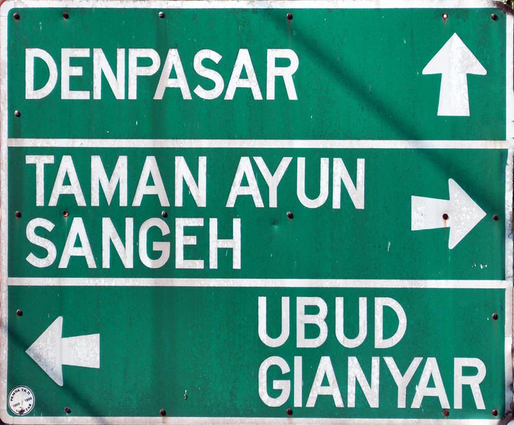 Road sign in Bali with direction arrows.  The direction left is Kiri in Indonesian.  Indonesian is the language spoken in Bali.