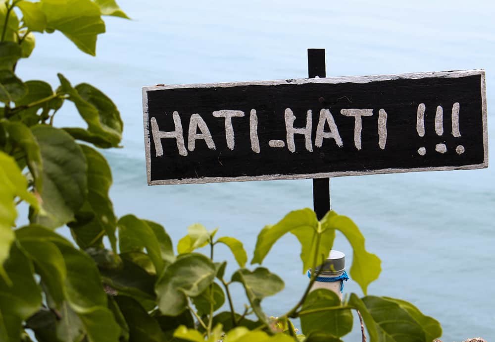 Hati Hati - Be Careful in Indonesian.  Indonesian is the language spoken in Bali.